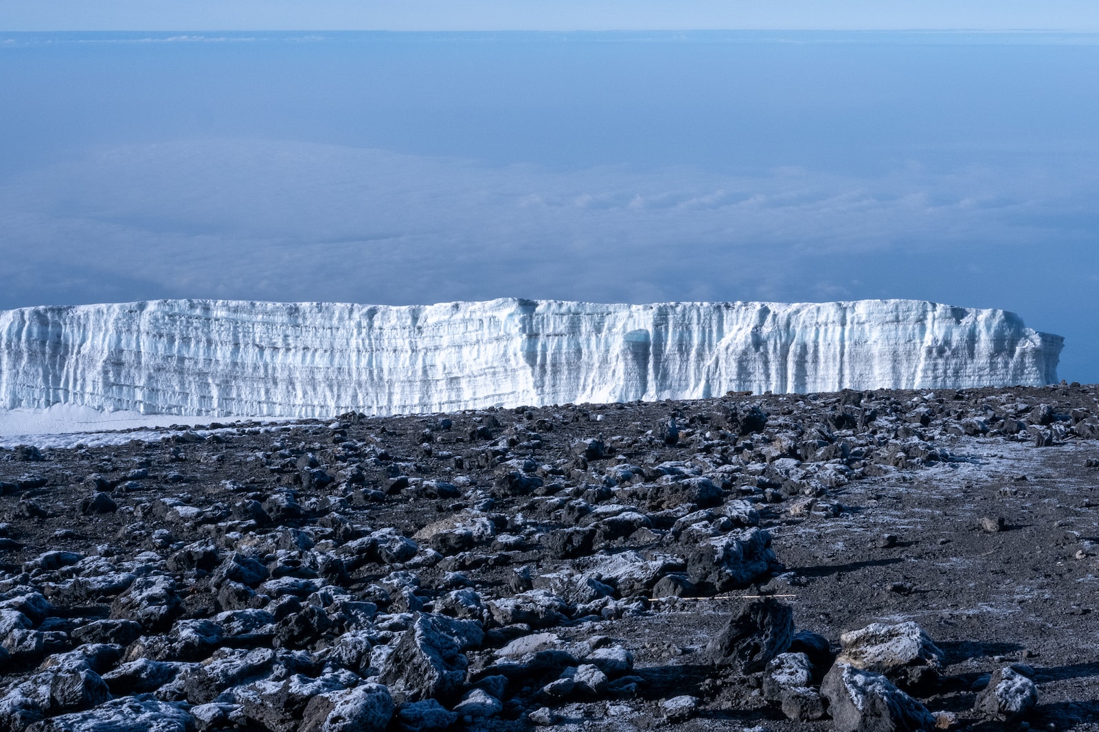 a rocky area with a large cliff in the background